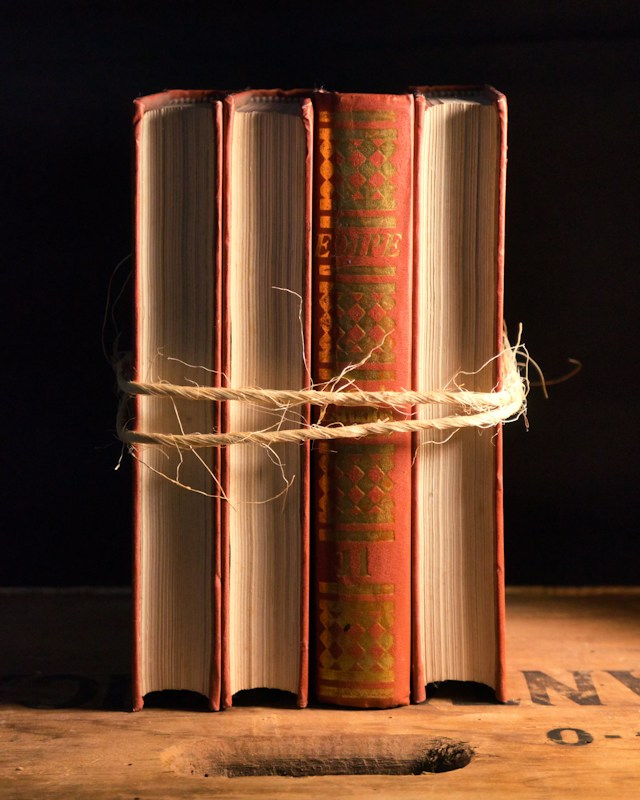 Four hardcover books tied with twine